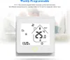 A thermostat is displayed in front of a blurred background of a couple and a child in bed. Produktbild-Vorschau