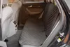 The interior of a car, showing the back seat covered with a black quilted seat cover. Produktbild-Vorschau