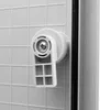 A close-up view of a white plastic handle mechanism on a gray textured surface, likely part of an electrical enclosure or cabinet. Náhled obrázku produktu