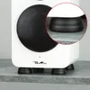 A close-up view of the bottom of a white speaker, showing the black rubber vibration-damping feet it rests on. A magnified inset circle highlights one of the feet. Produktbild-Vorschau