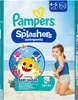 A child wearing swim pants on a beach with cartoon sharks. Podgląd zdjęcia produktu