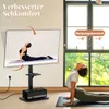 A woman is doing yoga in front of a TV stand with a TV displaying a yoga pose. Podgląd zdjęcia produktu
