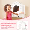 A young girl is playing with a toy vanity set, holding a makeup brush. Anteprima dell’immagine prodotto