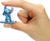 A hand holding a small Stitch figurine. Produktbild-Vorschau