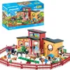 A Playmobil animal hotel playset with figures and accessories, shown with its packaging box above. Produktbild-Vorschau