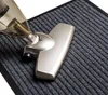 A vacuum cleaner head is shown cleaning a ribbed doormat. Anteprima dell’immagine prodotto