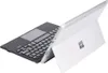 A silver tablet with a black keyboard attached, shown from a diagonal angle against a white background. Produktbild-Vorschau