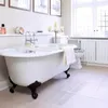 A bathroom with a clawfoot bathtub, toilet, and radiator. Produktbild-Vorschau