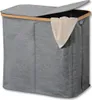 A gray laundry basket with a bamboo frame and a beige towel draped over the edge. Produktbild-Vorschau