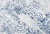 A close-up view of a rug with a distressed blue and white pattern. Produktbild-Vorschau