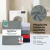 A stack of folded fitted sheets in various colors, with a close-up of gray fabric and a washing machine in the background. Produktbild-Vorschau