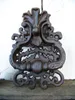 A dark brown, ornate cast iron door knocker is shown against a white background. Produktbild-Vorschau