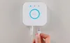 A hand is shown connecting an Ethernet cable to a white Philips Hue Bridge device mounted on a wall. Produktbild-Vorschau