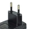 A close-up view of a black power adapter with two silver prongs. Produktbild-Vorschau