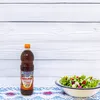 A bottle of Melfor vinegar and a salad are placed on a table with a patterned cloth. Produktbild-Vorschau