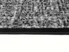 A close-up view of the edge of a rug with a black border. Náhled obrázku produktu