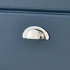 A close-up view of a silver drawer pull on a blue cabinet. Náhľad obrázku produktu