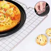 A pizza and muffins are shown on a cooling rack. Produktbild-Vorschau