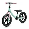 A mint green and pink balance bike with black wheels, shown from a three-quarter front angle against a white background. Produktbild-Vorschau