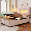 A pink upholstered bed with its storage compartment open, revealing stored items, in a bedroom setting with natural light. Produktbild-Vorschau