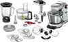 A collection of kitchen appliance parts and accessories, including a blender, food processor, and stand mixer attachments, laid out on a white background. Anteprima dell’immagine prodotto