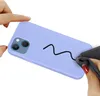 A hand is cleaning a purple phone case with a black wavy line drawn on it. Produktbild-Vorschau