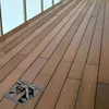 A metal fastening clip is shown on a wooden deck. Náhled obrázku produktu
