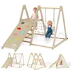 Two toddlers playing on a wooden indoor playground set with a slide, swing, and climbing net. Podgląd zdjęcia produktu