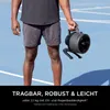 A person holding a portable fan on an outdoor court. Náhľad obrázku produktu
