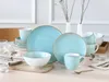 A table setting with a 16-piece dinnerware set in aqua and white, featuring plates, bowls, and mugs. Produktbild-Vorschau