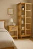 A bedroom scene with a nightstand and a tall cabinet. Podgląd zdjęcia produktu
