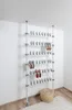 A telescoping shoe rack system is shown against a white wall. Produktbild-Vorschau