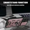 A close-up shot of a phone case with a ring holder, placed on a textured surface with headphones and a laptop in the background. Produktbild-Vorschau