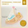A wooden toy sailboat with a whale design on its sail, placed in a bathtub or on a soft surface. Anteprima dell’immagine prodotto
