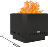 A black metal fire pit with flames on a white background, accompanied by a fire poker. Produktbild-Vorschau