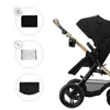 A close-up view of a black and gold stroller with accessories shown in circular insets on the left. Náhled obrázku produktu