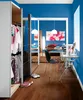 A bedroom with a closet, bed, and desk. Produktbild-Vorschau