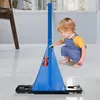 A young child plays with a blue toy car race track set indoors. Produktbild-Vorschau