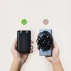 Two hands hold power banks, one with integrated cables and one with tangled cables, with smiley and sad faces above them. Produktbild-Vorschau