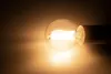 A close-up shot of a lit LED filament light bulb against a dark, gradient background. Produktbild-Vorschau