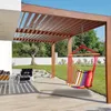 A colorful hammock chair hangs from a wooden pergola on a patio, with a lawn and trees in the background. Náhled obrázku produktu