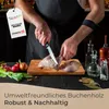 A person is cutting a piece of meat on a wooden cutting board, surrounded by ingredients and bottles. Produktbild-Vorschau