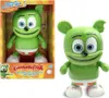 A green Gummy Bear toy is shown in its packaging next to a separate image of the toy. The packaging has text and graphics related to the product. Voir les images du produit