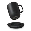 A black Ember mug is shown hovering above its charging coaster, both against a white background. Náhled obrázku produktu