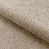 A close-up view of beige boucle fabric, showing its textured surface and folds. Náhled obrázku produktu