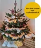 A decorated Christmas tree with lights and ornaments, placed indoors with a wooden crate nearby. Produktbild-Vorschau
