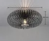 A black, wireframe-style ceiling light fixture with a single bulb, mounted on a white ceiling. Voir les images du produit