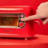 A hand is pressing a button on a red retro-style toaster. Voir les images du produit