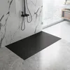A modern bathroom with a black shower tray, marble-effect wall tiles, and a large window overlooking a city. Náhľad obrázku produktu
