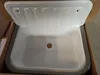 A new white sink basin with a gray rim, sitting in a cardboard box. Náhled obrázku produktu